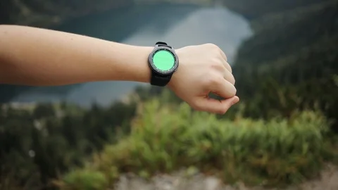 Close up young man hands gestures on a round screen modern smartwatch with a Stock Footage 95450581