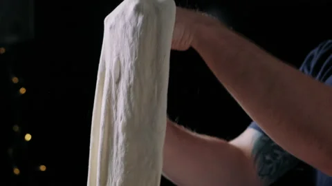 Close-up of young man hands getting sourdough pizza dough ready Stock Footage 132829492