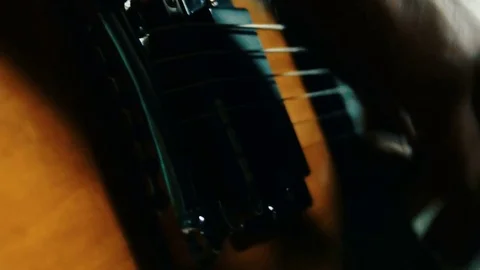 Close up of a young man hands playing a guitar, 4k Video stock 77488258