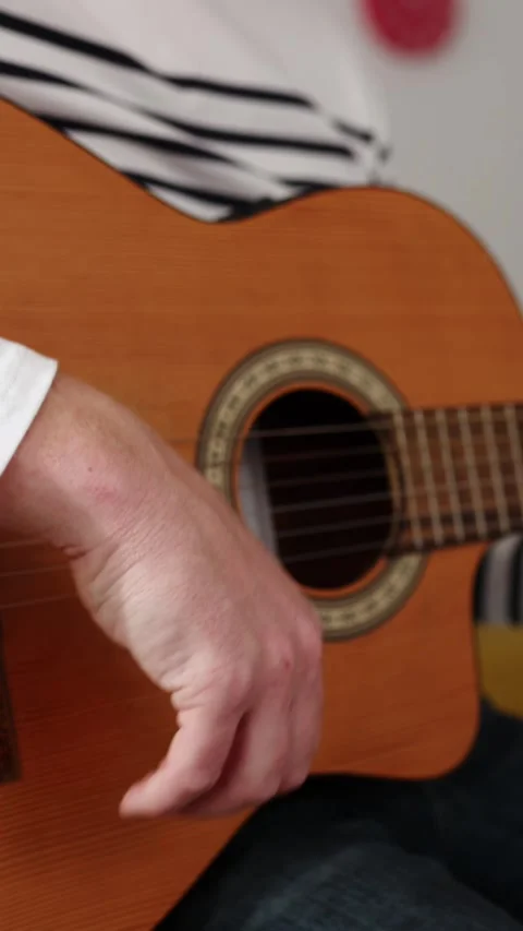 Close up young man hands playing the guitar while relaxing at home Stock Footage 312198800