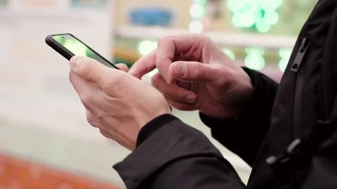 Close-up of young man hands using smartphone outdoors Stock Footage 135939998