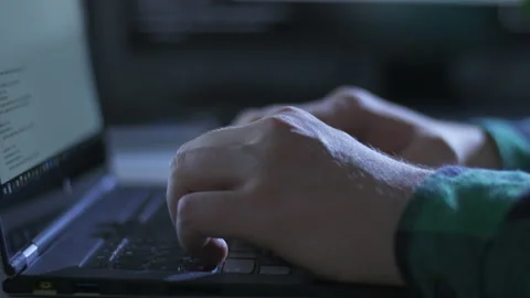 Close up of young man hands using laptop for programming at home Stock Footage 142975097