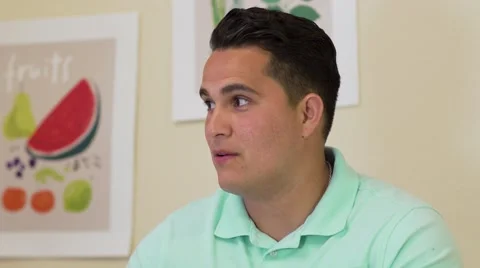 Close up of young man having a conversation in Kitchen 動画素材 64331088