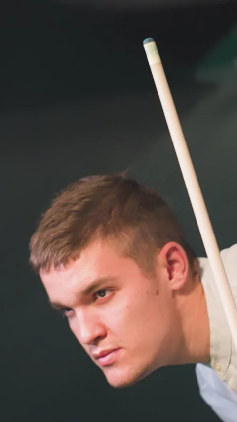 Close Up of Young Man Holding Cue Stick and Lemon Drink Under Overhead Lights Stock Footage 319793973