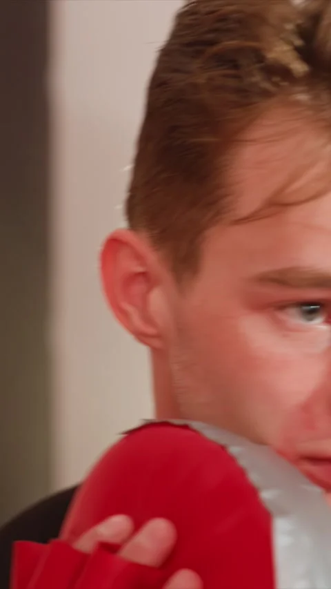 Close up of young man holding red boxing pad with fingerless gloves indoors Stock Footage 343093266