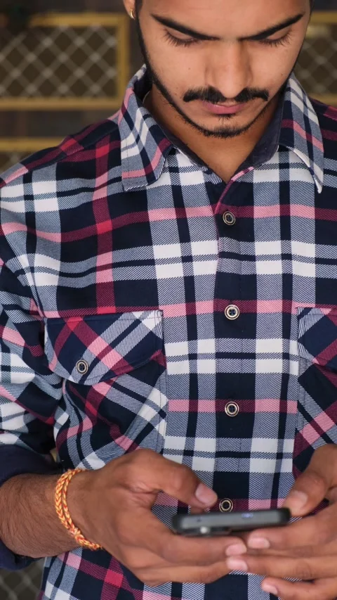 Close-up of a young man intensely using a smartphone indoors Stock-Footage 331354271