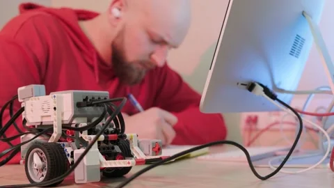 Close up of an young man that is learning robotics lessons using computer. Stock Footage 155651283