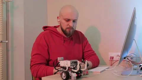 Close up of an young man that is learning robotics lessons using computer. Stock Footage 155761908