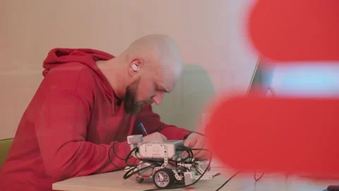 Close up of an young man that is learning robotics lessons using computer. Stock Footage 156338368
