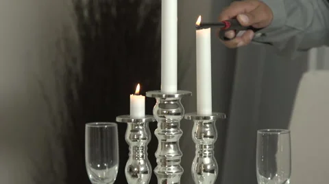 Close up of young man lighting candles at dinner table Stock Footage 44113495