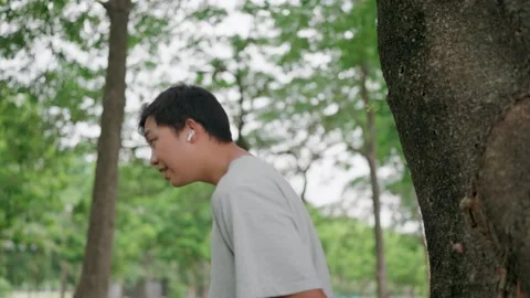 Close up Young man looking forward sadly and listening music with airpods  Stock Footage 283187167