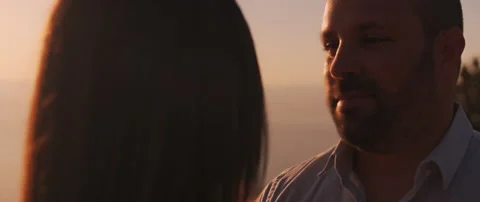 Close up of a young man looking at his girlfriend with love at sunset. Stock Footage 136242602