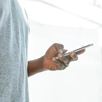Close up. young man looking at the screen of his smartphone. Stock Photos
