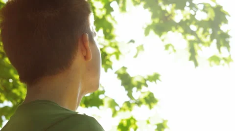 Close-up of young man looking at the sun Stock Footage 67254278