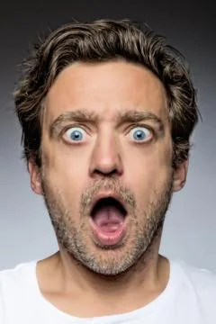 Close up of a young man looking surprised Stock Photos