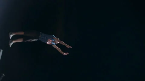 Close-Up of a Young Man Makes Extreme Jump From a Tower on an Air Cushion at Stock Footage 60681398