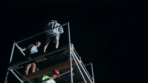 Close-Up of a Young Man Makes Extreme Jump From a Tower on an Air Cushion at Stock Footage 60681419