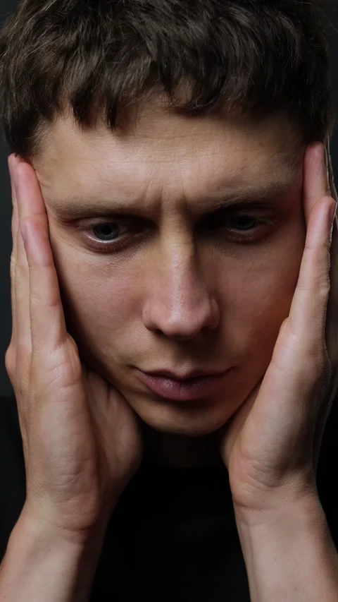 Close-up of young man massaging temples suffering from severe headache on black Stock Footage 318066721