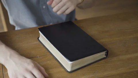 Close up of Young Man Opening the Bible and making notes on pages Stock Footage 111284087