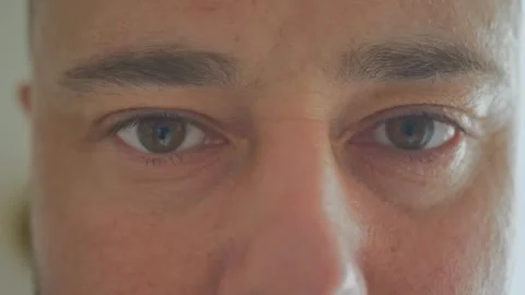 Close-up of a young man opening his eyes and blinking Stock Footage 254025090