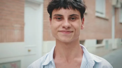 Close up, young man opens his eyes and smiles while looking at the camera Stock Footage 250843561