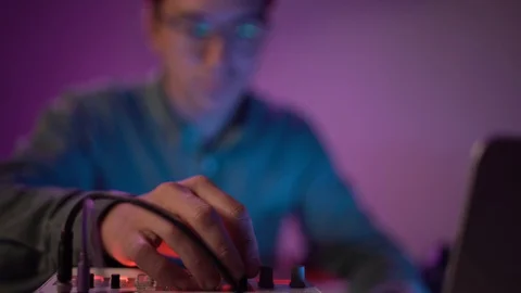 Close up, young man paying electronic synthesizer at the music studio Stock Footage 127580296
