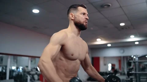 The close-up of the young man performing the lifting of the dumbbells with his Stock Footage 156471574
