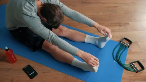 Close up of an young man performing stretch exercise at home. Stock Footage 144614414