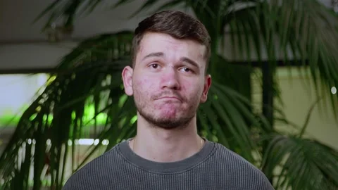 Close-up of a young man with pimples on his face. The guy is sad. Problematic Stock Footage 205301223