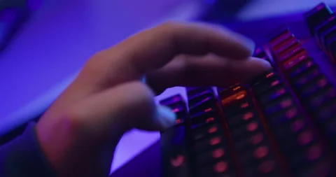 Close up, young man play computer games with his hand and keyboard Stock Footage 141927561