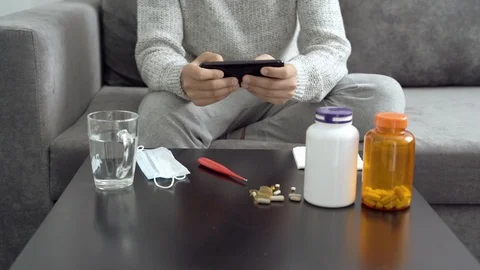 Close up of a young man playing a computer game on a smartphone during illness Stock Footage 110803586