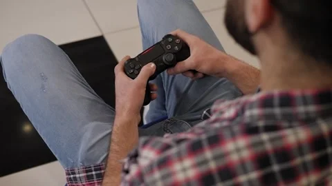 Close-up of a young man playing video games with a joystick in his hands. Stock Footage 267083043