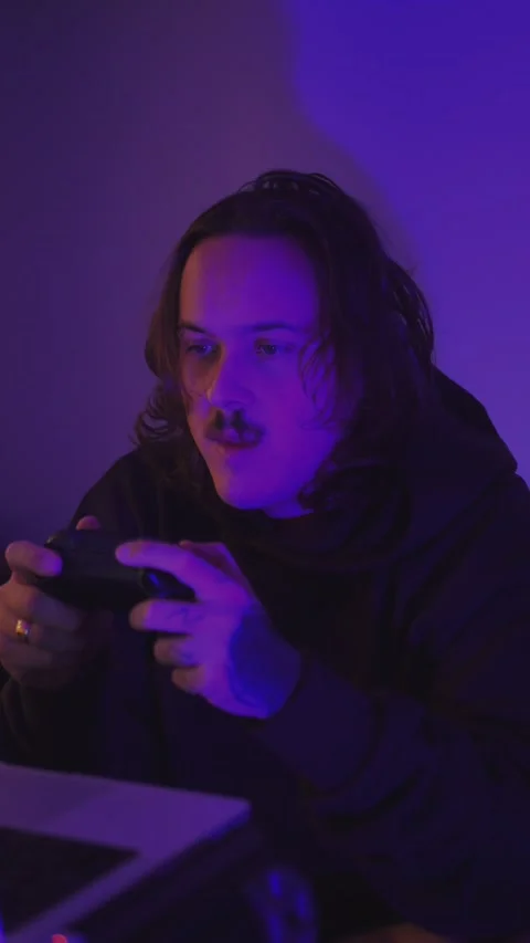 Close-up of a young man playing video games with... Stock Footage 337968364