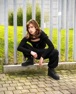 Close-up of young man posing in a crouch looking straight at the camera. Stock Photos