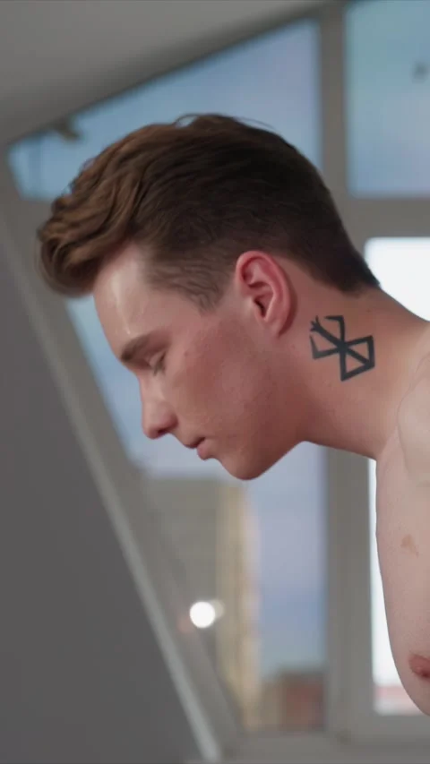 Close up of young man profile sweat acne tattoo shirtless exercise indoors by Stock Footage 344412098