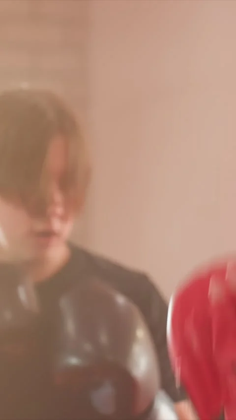 Close up of young man rapidly punching boxing focus mitts during sparring with Stock Footage 343089421