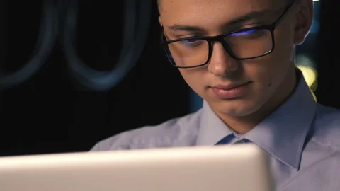 Close up of young man reading his tablet in the dark. dark background. Stock Footage 96492109