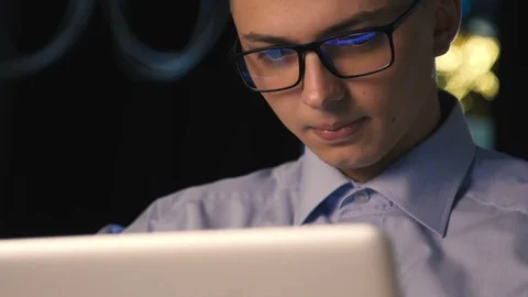 Close up of young man reading his laptop in the dark. dark background. Stock Footage 96492343