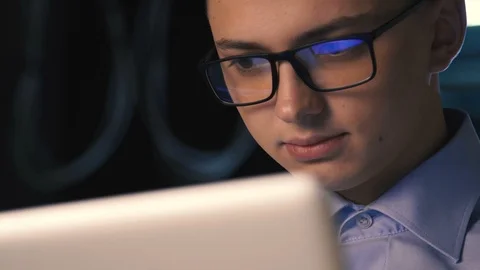 Close up of young man reading his laptop in the dark. dark background. Stock Footage 96492478