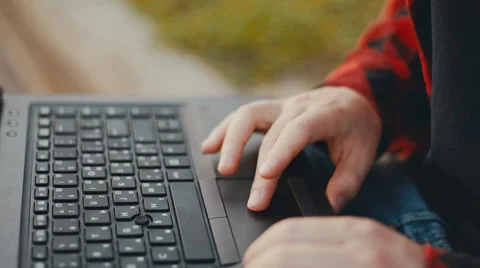 Close Up Young man sitting and using a laptop Stock Footage 67502747