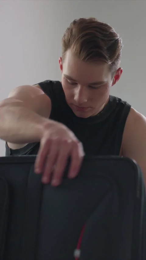 Close up young man sitting contemplative with black sleeveless shirt against 库存影片 343083999