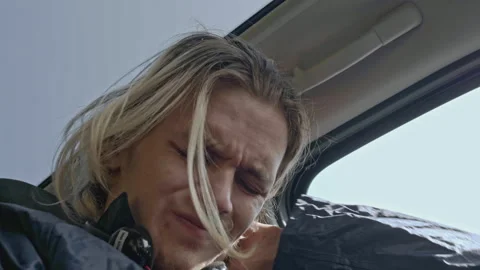 Close-up of young man sitting nervously in car. Stock. Man with panic attack is Stock Footage 277177649