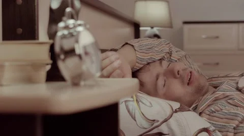 Close-up of young man is sleeping calmly and suddenly has a bad dream Stock-Footage 68421457