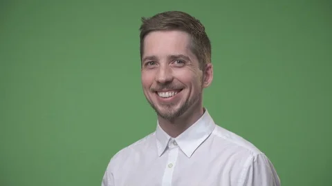 Close up of a young man smiling against green background Stock Footage 73151884
