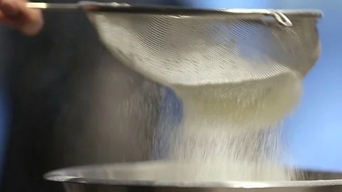Close up. The young man soweth flour for making cake. Stock Footage 72073366