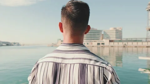 Close up, young man is standing on the pier. Back view Stock Footage 227104691