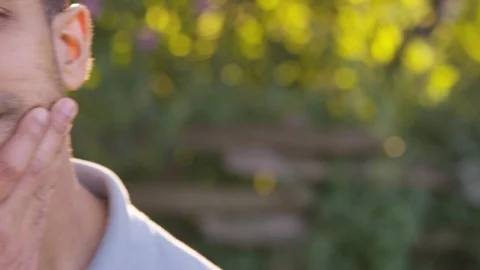 Close up young man stressed and worried, pan left. - Slow Motion - shot on RED Stock Footage 125167138