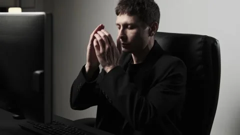 Close-up of young man stressed and anxious at computer desk, concept of mental Stock Footage 318442380