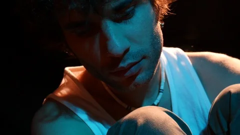 Close-up young man in studio with hot and cold neon light 스톡 동영상 126862102