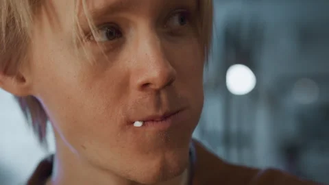 Close up of young man with subtle facial expressions and slight mouth movements Stock Footage 345734007